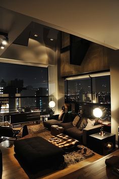 a living room filled with furniture next to a window covered in night time lightes