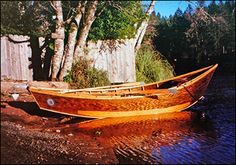 two wooden boats sitting on top of a lake