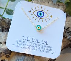 "Wear this lovely evil eye necklace as protection from the evil eye curse. The charm is a beautiful aqua blue with white, yellow and black in the center.  The evil eye is a malicious glare given to someone out of spite, malice, or envy, usually directed towards someone unaware of it.  The glare is considered to bring misfortune, suffering, or just general bad luck, so the evil eye talisman was created to wear for protection against this and to bring good luck.  This pretty glass evil eye charm floats along a dainty, shimmering chain and is double-sided, so the charm is visible from both sides. The charm is cylindrical, not flat, which really makes the evil eye amulet stand out.  The gold chain is delicate in appearance, but strong enough for everyday wear.  Wear your evil eye necklace alon Turquoise Evil Eye Bracelet As Gift, Nazar Necklace, Glass Evil Eye, Evil Eye Necklace Gold, The Evil Eye, Protection Necklace, Bad Luck, Blue Evil Eye, Bohemian Necklace