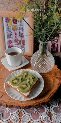 there is a plate with kiwi slices on it next to a cup of coffee