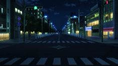 a person standing in the middle of an empty street at night with buildings lit up