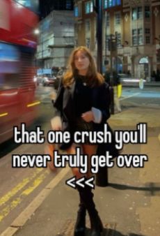 a woman standing on the side of a road next to a red bus