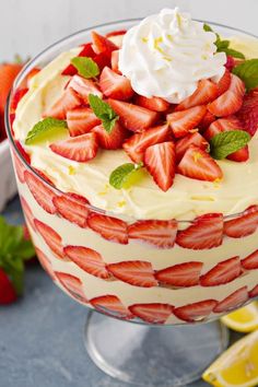 a lemon strawberry trifle with whipped cream and fresh strawberries