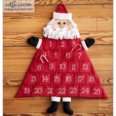 a santa claus calendar on the floor with numbers in red and white, as well as an image of his face