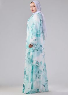 Immerse yourself in the luxury of our Elegance Floral Print Maxi Dress, crafted from premium chiffon and fully lined with soft polymix fabric. The high neck and flowing sleeves add a touch of sophistication to the delicate floral print, creating a piece that is both graceful and stylish. Whether for a special occasion or an elegant day out, this dress will elevate your modest fashion collection. The adjustable tie at the neck allows for a customized fit, ensuring comfort and elegance in every we Floral Print Chiffon Maxi Dress, Dress With High Neck, Print Chiffon Maxi Dress, Flowing Sleeves, Floral Print Chiffon, Abaya Dress, Floral Print Maxi Dress, Floral Print Maxi, Chiffon Maxi