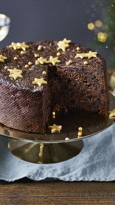 a chocolate cake with gold stars on top