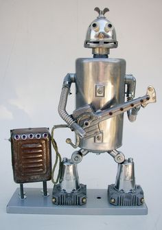 a metal robot with an electric guitar attached to it