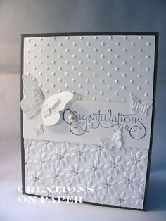 congratulations card with white paper and butterflies on the front, in black and white colors