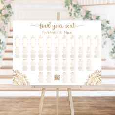 a wedding seating chart on an easel with pink flowers in the background and gold lettering