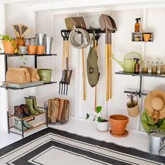 a room filled with lots of different types of gardening tools and pots on shelving