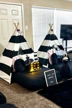 two teepee tents are set up in the living room