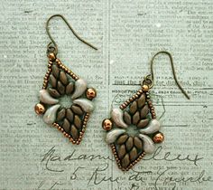 the earrings are made with copper and white beads