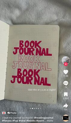 the book journal is open and has red lettering on it