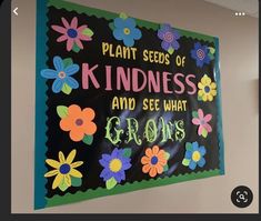 a sign that says plant seeds of kindness and see what grows on the wall