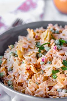 a close up of a bowl of food with peas and other things in the background