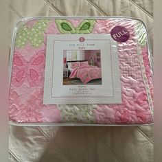 a pink and green bed in a box