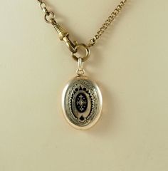 A charming antique Victorian oval mourning locket back pendant. In 8k gold, acid tested, the locket is decorated to the front with chasing and black enamel lozenges.   The reverse panel with machine engraving. Opening to reveal space for two photographs with two gilt frames and both glass coverings, one badly damaged, see photographs. The chain is for display only. Germany 1880s. Space for photographs 2.2cm x 1.5cm.  In inches 7/8" x 1/2". The locket 2.7cm x 2.1cm.  In inches just over  1" x 6/8 Engraved Oval Link Locket Necklace For Wedding, Oval Locket Necklace For Vintage Collection, Victorian Medallion Jewelry With Engraving Option, Victorian Oval Jewelry With Engraving Option, Heirloom Oval Locket Necklace, Victorian Oval Locket Necklace With Intricate Design, Victorian Style Locket Necklace With Oval Pendant, Antique Oval Pendant Locket Necklace For Formal Occasions, Antique Formal Locket Necklace With Oval Pendant