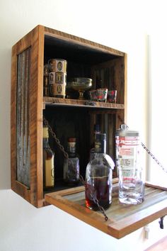 a wooden shelf with bottles and glasses on it