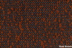 an orange and blue carpet with some black dots on the bottom, and one brown dot in the middle