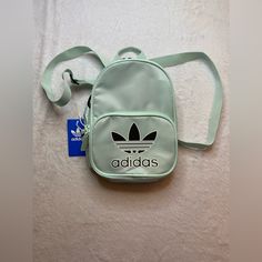 Adidas Originals Santiago Mini Backpack Ice Mint Green 10” Nwt Msrp $35 #Ev7591 Brand New With Tags. Only Usa Shipping And No International Shipping. Will Ship With In 3 Business Days After Payment Has Been Made. I Do Combine/Bundle Shipping. I Do Use Recycled Shipping Items To Stay Eco Friendly For Our Beautiful Earth. Please Leave Positive Feedback, And I Will Return Positive Feedback For Better Customer Satisfaction, Thanks. Adidas Green Backpack, Adidas Bags, Mini Backpack, Positive Feedback, Adidas Women, Customer Satisfaction, Mint Green, Adidas Originals, Eco Friendly