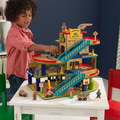 The KidKraft Wash n Go Wooden Car Garage was a Toy of the Year Awards finalist in 2017. Packed with interactive fun, this playset will keep kids engaged and having imaginative fun for hours. Kids can take the included wooden cars up the elevator to the top floor where a helicopter waits on its pad. Zoom down the ramps past the mechanic’s shop and smiling townsfolk to the car wash with its spinning brushes. Fuel up at the gas station, then it’s back to the elevator to do it all again. This playse Wooden Car Garage, Toy Race Track, Play Teepee, Pirates Cove, Wooden Playset, Wash N Go, Wooden Easel, Wash And Go, Wooden Car