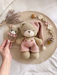 a person holding a small stuffed animal on top of a white plate with other items