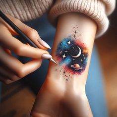 a woman's arm with a tattoo on it and stars, planets and the moon