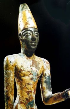 an ancient egyptian statue is shown in this image, it appears to be painted gold