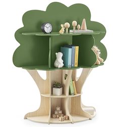 a green tree shelf with books, toys and other items on it in front of a white background