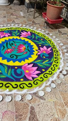 a colorful rug on the ground with flowers painted on it