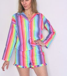 The perfect retro style button up pajama top, paired with cute ruffle shorties in lightweight and breathable cotton. Bright rainbow striped crisp cotton poplin, with white flower snaps. Super cute as a casual beach or lounge set as well! Comfortable boxy fit, with snap buttons, collar, and options of long sleeved or cuffed short sleeves. Top hits at hip length, and short sleeves and long sleeves are available options. Shorties have 2 inch inseam; pants have a 29 inch inseam; both have a high ris Button Up Pajamas, Cotton Pajama Set, Top Hits, Bright Rainbow, Cotton Pajama Sets, Plus And Minus, Pajama Robe, Cuffed Shorts, Cotton Pyjamas