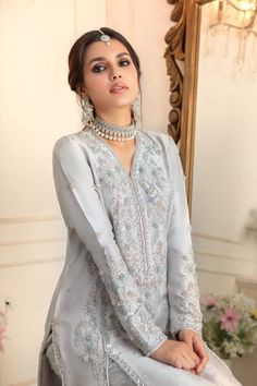 Calla Festive Silver Dress With Resham Embroidery, Silver Kurta With Zari Work For Wedding, Silver Wedding Kurta With Zari Work, Party Sharara With Pearl Embroidery In Raw Silk, Hand Embellished Party Wear Salwar Kameez For Festive Occasions, Bollywood Style Silver Kurta For Wedding, Eid Silver Salwar Kameez With Dabka Work, Raw Silk Sets With Pearl Embroidery For Party, Fitted Hand Embellished Party Wear Salwar Kameez