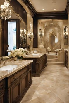 a large bathroom with double sinks and chandelier in it's center area