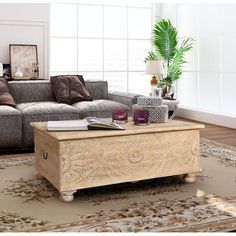 a living room with a couch, coffee table and rug