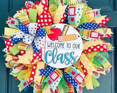 a welcome to our class wreath on the front door