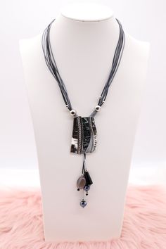 The "Silver and Black Metal Pendant with Dangling Stones, Multi Black and Silver Rope Necklace" showcases a sophisticated pendant combining silver and black metal, adorned with elegantly dangling stones that add movement and sparkle. This pendant hangs from a necklace made of intertwined black and silver ropes, creating a dynamic and textured look that is both modern and striking. Length: 18” (18 extensions) Pendant: 2.03” (Length) 1.40” (Width) Closure: Lobster Claw Clasp Material: Brass with S A Necklace, Rope Necklace, Black Necklace, Metal Pendant, Black And Silver, Tennis Bracelet, Christmas Sale, Lobster Claw, Black Metal