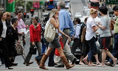 many people are crossing the street and walking