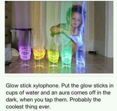 a girl is playing with colored cups on the floor and text reads glow stick xylphone put the glow sticks in cups of water and an aura comes off in the dark, when you tap them