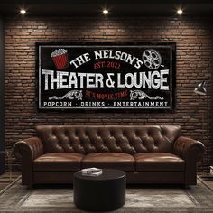 a brown leather couch in front of a brick wall with the words theater and lounge on it