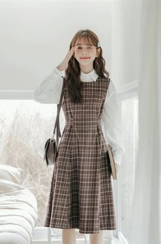 Round neck sleeveless plaid midi dress with thick shoulder straps in an all-over plaid print. Zips up at the back with a tie-waist and side pockets. Perfect for layering with your favorite blouse or sweater. S: 35" chest, 29" waist, 41.5" lengthM: 36.5" chest, 30.5" waist, 41.5" lengthL: 38" chest, 32" waist, 41.5" length Casual Plaid Midi Dress For Daywear, Casual Fall Pinafore Dress For Workwear, Chic Plaid Midi Dress For Fall, Plaid Midi Dress For Work, Casual Plaid Midi Dress For Work, Sleeveless Plaid Dress For Work, Plaid Midi Length Dress For Work, Casual Sleeveless Pinafore Dress For Fall, Plaid Midi Length Dress For Daywear