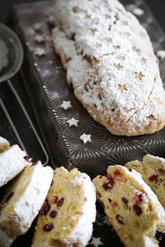 several pastries are sitting on a tray with powdered sugar sprinkles