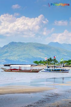 two boats floating on top of a body of water