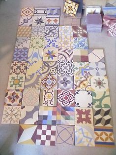 the floor is covered in many different colored tiles