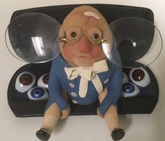 an odd looking toy with glasses on it's head