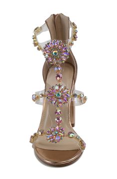 Prismatic rhinestones dazzle the clear straps of this radiant sandal finished with a handy back heel closure. 3 1/4" heel Water-resistant Synthetic upper and lining/rubber sole Imported Glamorous Sandals With Clear Strap And Open Toe, Glamorous Open Toe Sandals With Clear Strap, Glamorous Clear Sandals For Spring, Glamorous Sandals With Clear Ankle Strap, Crystal High Heel Shoes For Spring, Crystal Open Toe Heels For Summer, Glamorous Clear Open Toe Sandals, Crystal Open Toe Heels For Prom, Summer Crystal High Heels