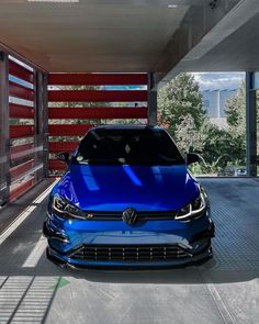 a blue car parked in front of a building