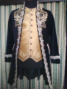 This enchanting male costume was inspired by the atmosphere of magical Venice Carnival and an unrepeatable fashion of Rococo Epoch. It consists of: - a white cotton silk shirt with the necktie; - yellow jacquard vest; - dark blue justacorps made of natural cotton velvet with metal buttons; - black pants. The vest is decorated with handmade embroidery and laces. Every detail of the costume is created and attached by hand. The costume can become the zest of any carnival and theme ball, will perfec Blue Rococo Dresses For Costume Party, Baroque Male Fashion, Rococo Menswear, Blue Baroque Costume Dress, Blue Rococo Costume Dress, Rococo Wedding, Rococo Costume, Elven Dress, Venice Carnival Costumes