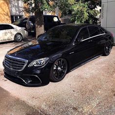 a black car parked in front of a building