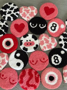 several different types of buttons with hearts and numbers on them, all decorated in pink and black