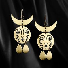 Horned Mother Moon earrings with etched faces comprised of weeping flowers and a waning crescent crown. For more companions of the Horned Mother Moon Earrings, check out our Classics collection. 2.4" in length x 1.2" in width nickel free brass pendants. Available with gold filled hooks. For a necklace version of the Horned Mother Moon design, check here. These have black enamel filled details. They are also powder coated to prevent the metal from oxidizing, preserve the enamel and makes the ... Yellow Gold Brass Plug Earrings, Artistic Gold Hoop Earrings With Ear Wire, Bronze Moon-shaped Brass Jewelry, Hypoallergenic Brass Bohemian Jewelry, Hypoallergenic Gold-tone Brass Jewelry, Brass Moon Shaped Festival Earrings, Moon-shaped Brass Earrings For Festival, Artistic Gold Nickel-free Earrings, Festival Moon-shaped Brass Earrings